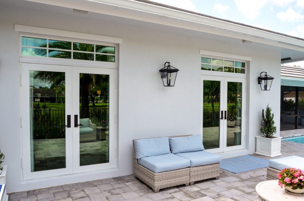 White-framed glass patio doors with transom windows
