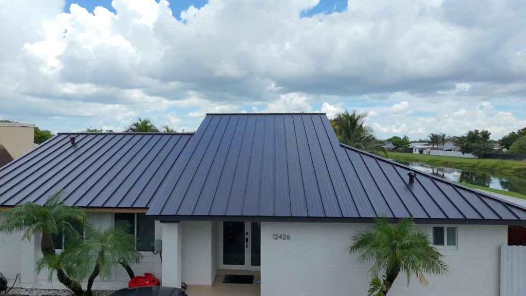 Standing seam metal roof on a white residential property